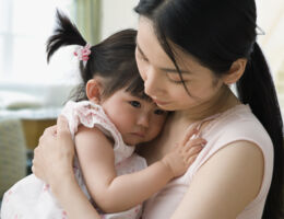  A woman comforts a toddler